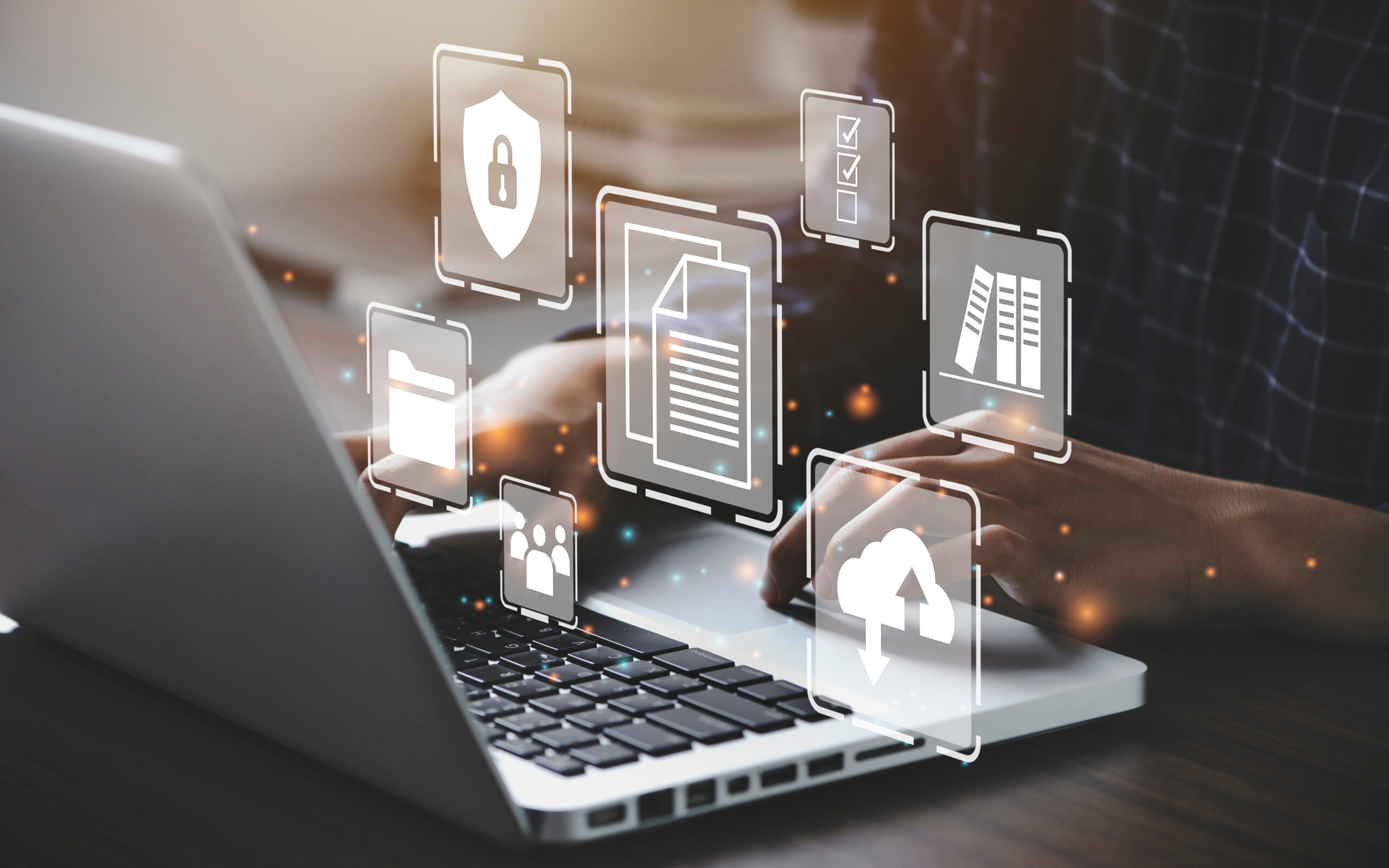 Hands typing on a laptop with holographic icons of security, cloud storage, file sharing, and user management overlayed, representing secure remote desktop solutions.