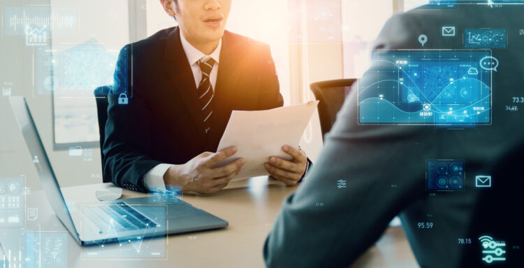 A nonprofit leader discusses IT challenges with a consultant, surrounded by digital technology graphics, symbolizing data security and operational efficiency in the nonprofit sector.